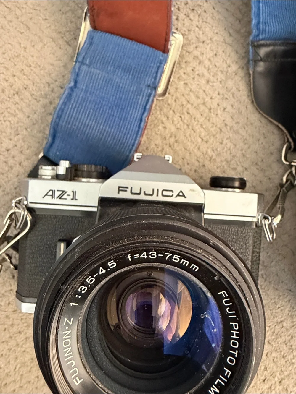 35mm Film Camera with Blue and Brown Strap and Black Telephoto Lens